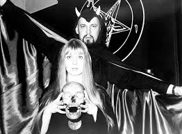 Satananic mass, Anton Lavey, and a woman holding a skull. 