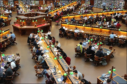 God Does NOT Exist Books Free: People in a public library reading books. 